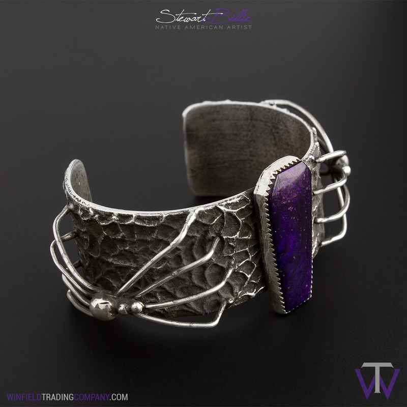 Things are getting Spooky! We decided to design this around the old scary film look. This Intricate Tufa Cast Bracelet is by Stewart Billie. From the detailed texture of the webs to the smooth cuts of the Coffin shaped Sugilite, this bracelet is sure to set the halloween mood.